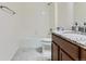 Bright bathroom featuring a tiled shower-tub, granite countertop, and modern fixtures at 15195 E 16 Th Pl # 104, Aurora, CO 80011