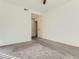 Neutral bedroom featuring carpet and a view of a hallway with multiple doors at 15195 E 16 Th Pl # 104, Aurora, CO 80011