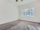 Bedroom with neutral carpet, a ceiling fan, and a large window providing natural light at 15195 E 16 Th Pl # 104, Aurora, CO 80011