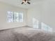 Spacious bedroom with natural light from a window, neutral carpet, and ceiling fan at 15195 E 16 Th Pl # 104, Aurora, CO 80011