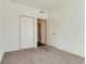 Neutral carpet in a bedroom with a double door closet and an open doorway to the bathroom at 15195 E 16 Th Pl # 104, Aurora, CO 80011