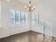 Dining area featuring plantation shutters, hardwood floors, and a modern chandelier at 15195 E 16 Th Pl # 104, Aurora, CO 80011