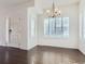 Open dining area with plantation shutters, hardwood floors, and an elegant chandelier at 15195 E 16 Th Pl # 104, Aurora, CO 80011