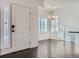 Bright entryway with white trim, dark floors, chandelier, and plentiful natural light at 15195 E 16 Th Pl # 104, Aurora, CO 80011