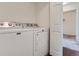 Laundry room with Maytag washer and dryer, and a glimpse of a carpeted room through the doorway at 15195 E 16 Th Pl # 104, Aurora, CO 80011