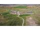 Aerial view of a park with playground, open green space, and walking trails at 5900 Haywagon Ln, Castle Rock, CO 80108