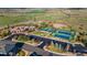 Aerial view of community amenities including tennis courts, swimming pool, clubhouse, parking lot, and scenic green spaces at 5900 Haywagon Ln, Castle Rock, CO 80108