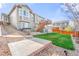 Backyard view featuring a well-maintained lawn, hot tub, wooden deck with stairs, and professional landscaping at 5900 Haywagon Ln, Castle Rock, CO 80108
