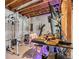 Unfinished basement with exercise equipment, and a desk with computer setup, surrounded by plastic-covered, framed-in walls at 5900 Haywagon Ln, Castle Rock, CO 80108