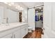 Bathroom featuring a double vanity and a sliding barn door to the closet at 5900 Haywagon Ln, Castle Rock, CO 80108