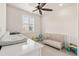 Bright bedroom with a ceiling fan, window with blinds, and crib at 5900 Haywagon Ln, Castle Rock, CO 80108
