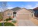 Charming single Gathering home showcasing a two-car garage and beautiful stone accents at 5900 Haywagon Ln, Castle Rock, CO 80108