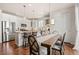 Open kitchen with stainless steel appliances, island, and granite countertops at 5900 Haywagon Ln, Castle Rock, CO 80108