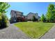 Lush green lawn, gravel landscaping and two-story home in the background at 7081 S Oak Hill Cir, Aurora, CO 80016