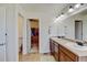 Bathroom with dual sinks, walk-in closet, toilet and vanity with plenty of room for storage at 7081 S Oak Hill Cir, Aurora, CO 80016
