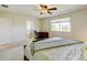 Carpeted main bedroom with ceiling fan, desk, and adjoining bathroom with shower and tub at 7081 S Oak Hill Cir, Aurora, CO 80016