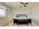 Comfortable carpeted bedroom includes window, ceiling fan, and stylish furniture at 7081 S Oak Hill Cir, Aurora, CO 80016