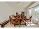 Spacious dining area with a long wooden table and bright natural light at 7081 S Oak Hill Cir, Aurora, CO 80016