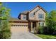 Charming two-story home featuring a well-manicured lawn and attached two car garage at 7081 S Oak Hill Cir, Aurora, CO 80016