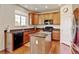 Kitchen with updated stainless appliances, an island, and modern cabinetry at 7081 S Oak Hill Cir, Aurora, CO 80016