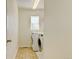 Well-lit laundry room with front-loading washer and dryer, and tiled flooring at 7081 S Oak Hill Cir, Aurora, CO 80016
