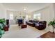 Bright living room featuring a fireplace, comfortable seating, and ample natural light at 7081 S Oak Hill Cir, Aurora, CO 80016