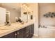 Bathroom with double sinks, vanity, and a large soaking tub at 3411 N Xenia St, Denver, CO 80238