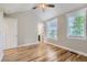 Bright bedroom featuring hardwood floors, neutral walls, white trim and two windows allowing ample natural light at 3411 N Xenia St, Denver, CO 80238