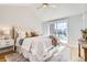 Comfortable bedroom featuring a vaulted ceiling, plush bedding, and a private balcony at 3411 N Xenia St, Denver, CO 80238