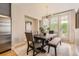 Inviting dining room featuring modern light fixture and seamless outdoor access at 3411 N Xenia St, Denver, CO 80238
