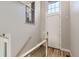 Bright entryway with a staircase, light hardwood floors and a charming high window at 3411 N Xenia St, Denver, CO 80238