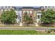 Charming multi-colored townhome featuring landscaped front yards and inviting entryways at 3411 N Xenia St, Denver, CO 80238
