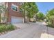 Row of garages along a tree-lined street, showcasing the community's convenient parking options at 3411 N Xenia St, Denver, CO 80238