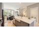Bright kitchen with marble countertop island, stainless steel appliances, hardwood floors, and adjacent dining area at 3411 N Xenia St, Denver, CO 80238