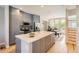 Spacious kitchen with an island, stainless steel appliances, ample cabinet space, and hardwood floors at 3411 N Xenia St, Denver, CO 80238