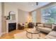 Cozy living room with a fireplace, neutral decor, and a comfortable seating arrangement at 3411 N Xenia St, Denver, CO 80238
