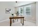 Office featuring a wood desk, modern decor, and two windows which provide plenty of natural light at 3411 N Xenia St, Denver, CO 80238