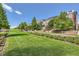 Scenic street view with manicured lawn, trees, and well-maintained townhomes at 3411 N Xenia St, Denver, CO 80238