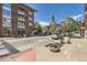 Charming street view with modern brick buildings, street-side parking, and decorative planters at 3411 N Xenia St, Denver, CO 80238