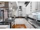 Bright kitchen featuring white cabinets, black granite countertops, and stainless steel appliances at 1020 15Th St # 214, Denver, CO 80202