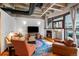 Cozy living room boasting a fireplace, TV, comfortable seating, and abundant natural light from large windows at 1020 15Th St # 214, Denver, CO 80202