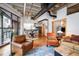 Open concept living space featuring hardwood floors, a modern kitchen, and comfortable seating arrangements at 1020 15Th St # 214, Denver, CO 80202