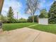 Expansive backyard featuring a large grassy area, mature trees, and a storage shed at 2797 S Newton Way, Denver, CO 80236