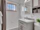 Cozy bathroom with gray vanity, tub-shower combo, and ample natural light at 2797 S Newton Way, Denver, CO 80236