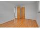 Bedroom featuring hardwood floors and built-in closet and doors at 2797 S Newton Way, Denver, CO 80236
