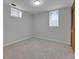 Empty bedroom with two windows, carpeted floor, and standard closet at 2797 S Newton Way, Denver, CO 80236