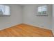 Simple bedroom with hardwood floors and white walls and windows at 2797 S Newton Way, Denver, CO 80236