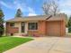 Charming exterior of a brick and siding home with a well-manicured lawn and a wide driveway at 2797 S Newton Way, Denver, CO 80236