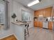 Contemporary kitchen with breakfast bar and warm wood cabinetry at 2797 S Newton Way, Denver, CO 80236