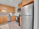 Kitchen with stainless steel appliances and ample wood cabinet space at 2797 S Newton Way, Denver, CO 80236